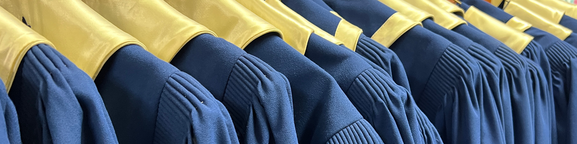 Blue choir robes hanging in a row
